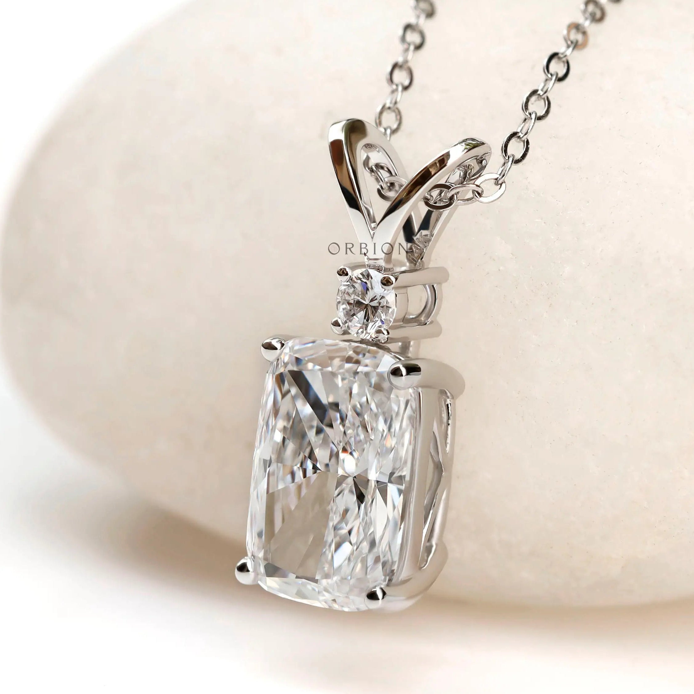 Angled front view of cushion diamond pendant in white gold.