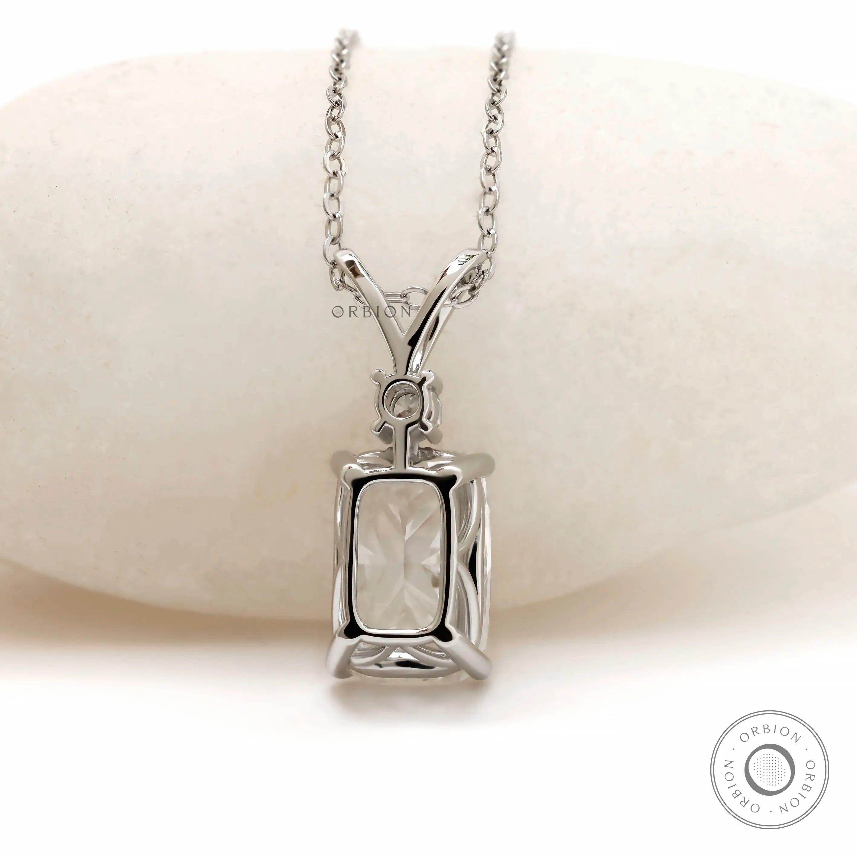 Back view of white gold pendant with structured gallery.