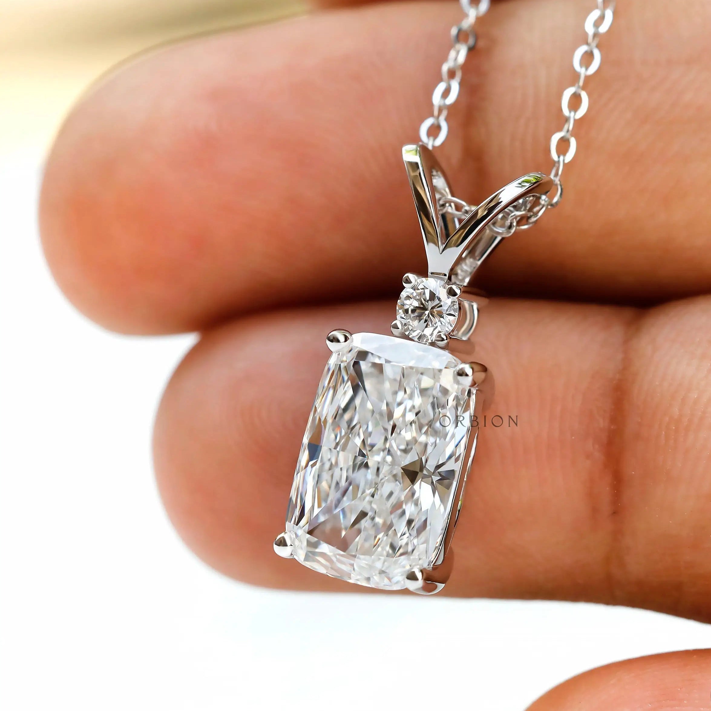 Angled close up of split V bail diamond pendant.