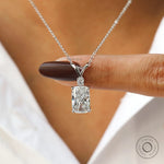 Finger held view of elongated cushion lab diamond pendant.