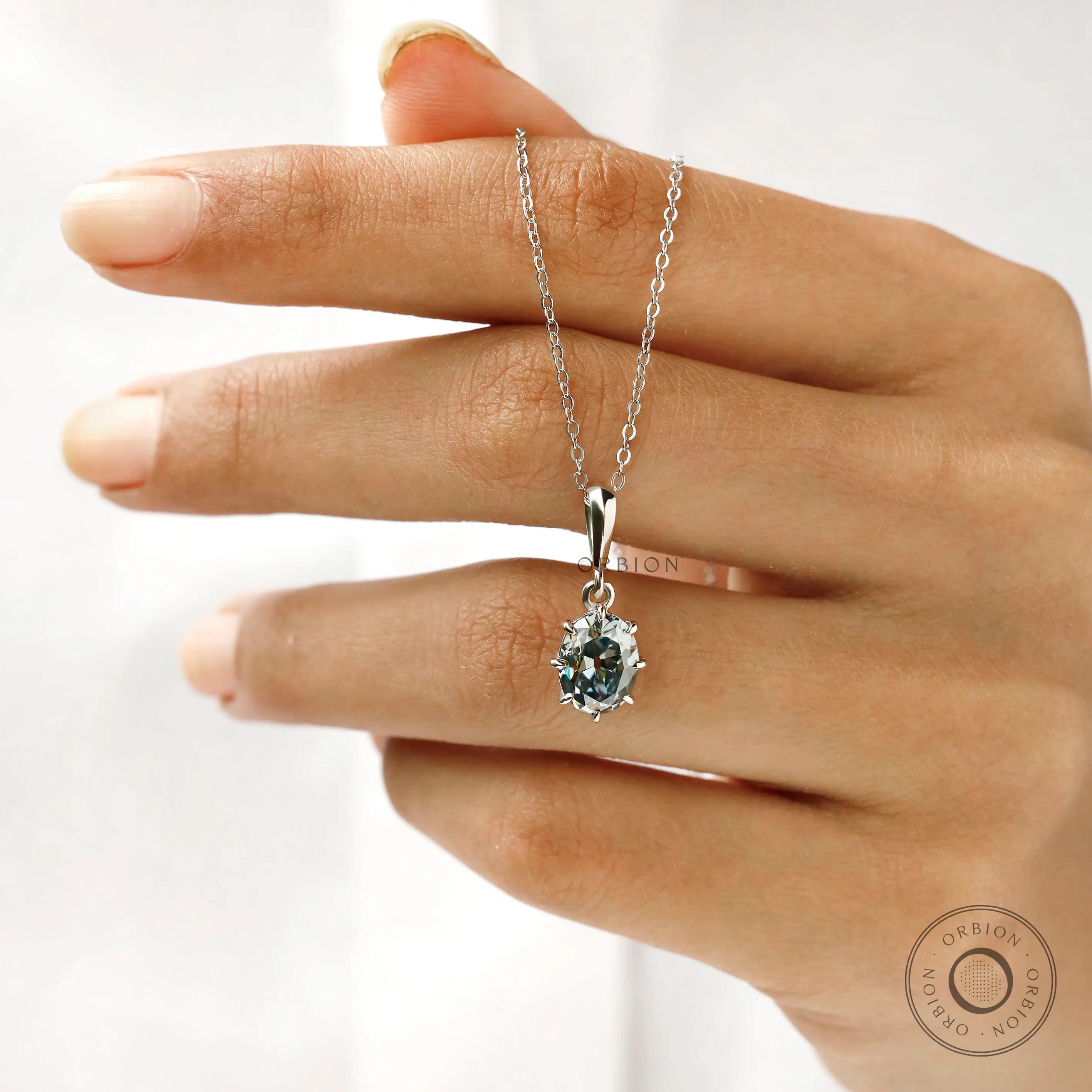 White gold oval moissanite pendant with classic solitaire design