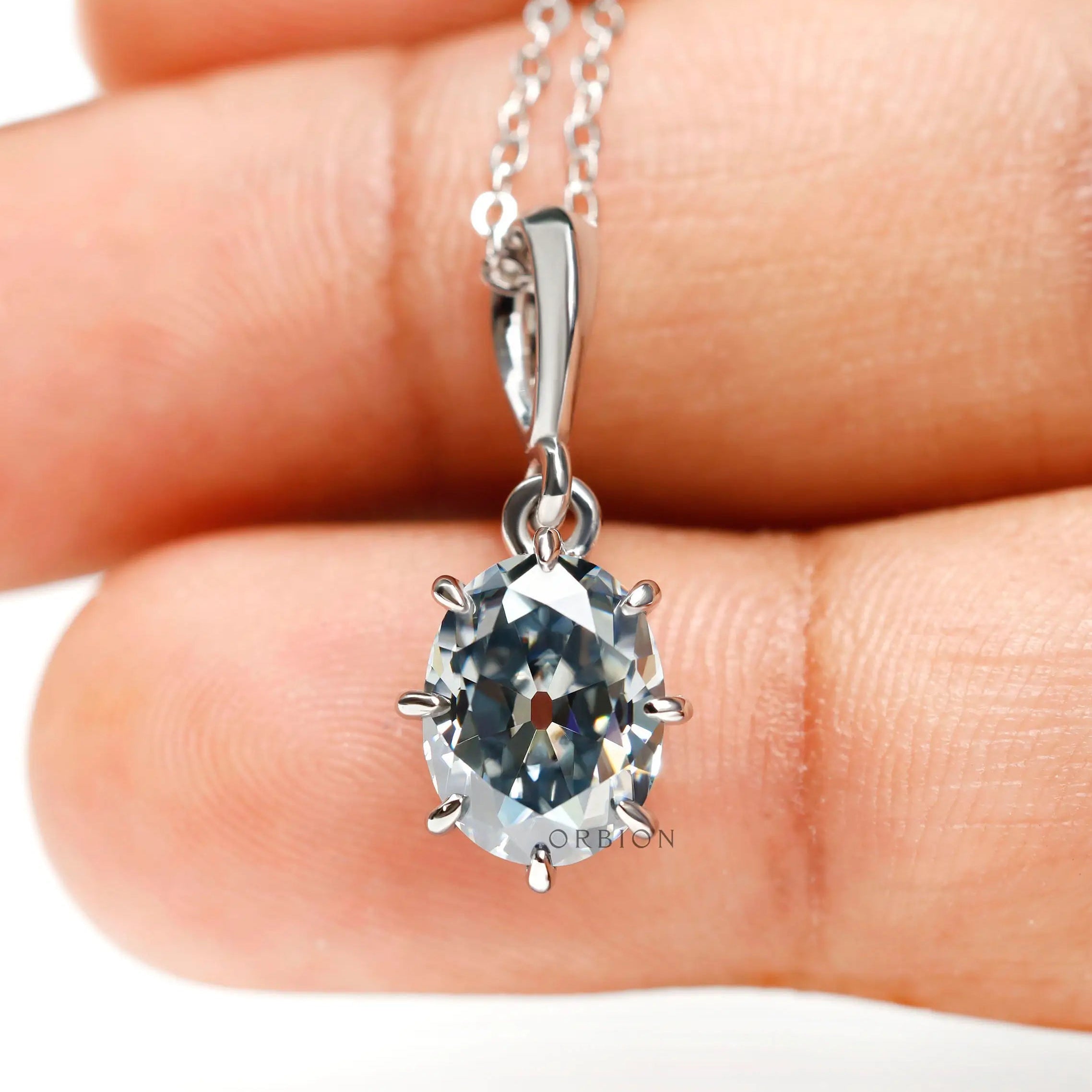 Oval old mine cut bluish grey moissanite pendant in 10k white gold