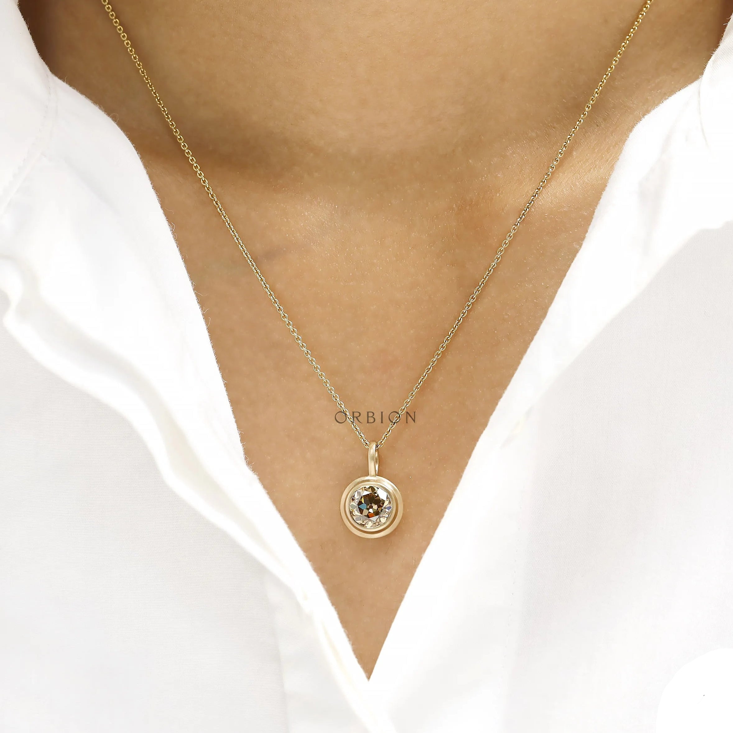 Fine jewelry pendant featuring 1.50 Ct champagne moissanite, bezel set in 10k yellow gold