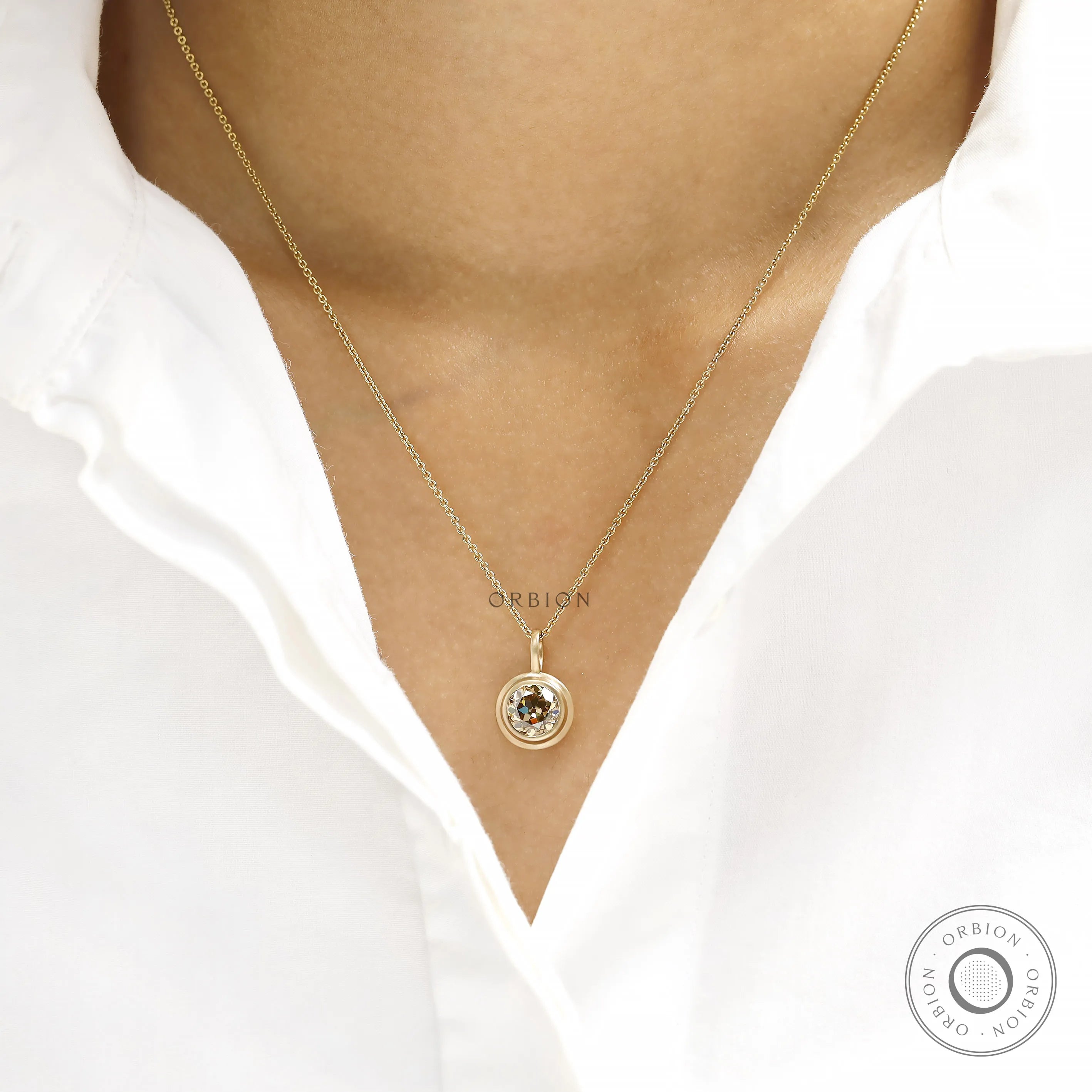 Fine jewelry pendant featuring 1.50 Ct champagne moissanite, bezel set in 10k yellow gold