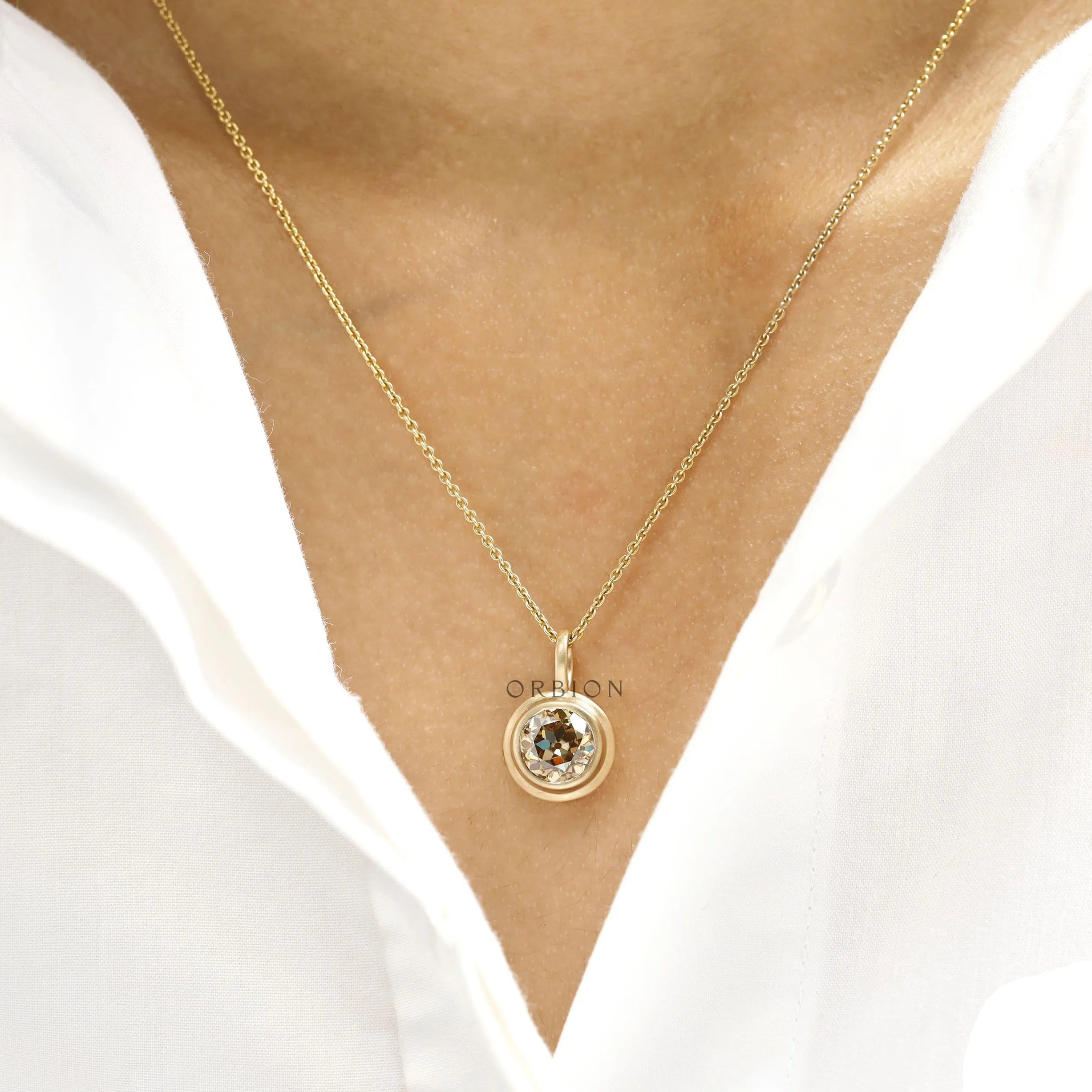 Elegant old european cut moissanite pendant in yellow gold bezel with brushed matte finish