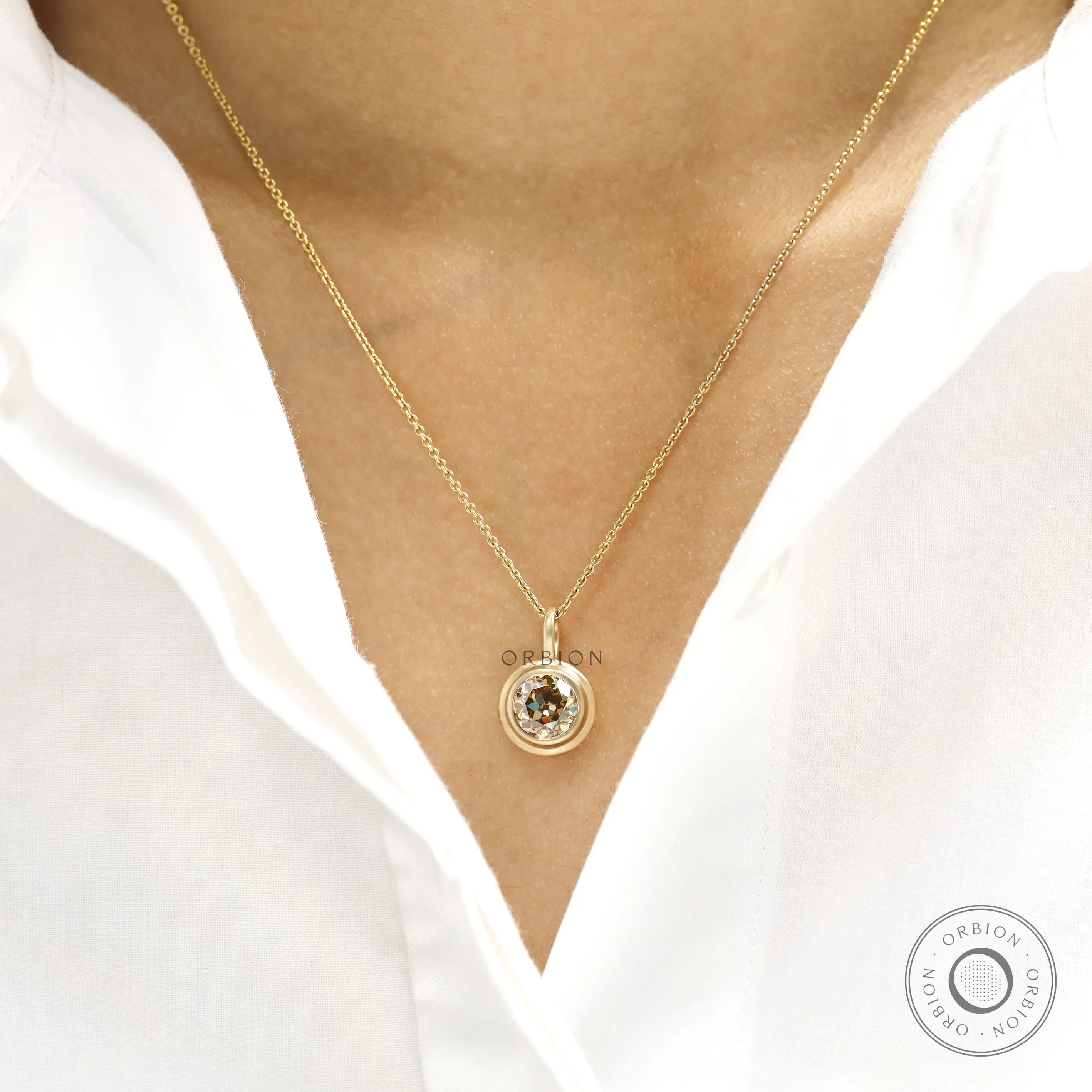 Elegant old european cut moissanite pendant in yellow gold bezel with brushed matte finish