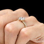 Bezel set oval moissanite ring on finger view