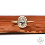 Oval bezel set engagement ring in 14K yellow gold on front view