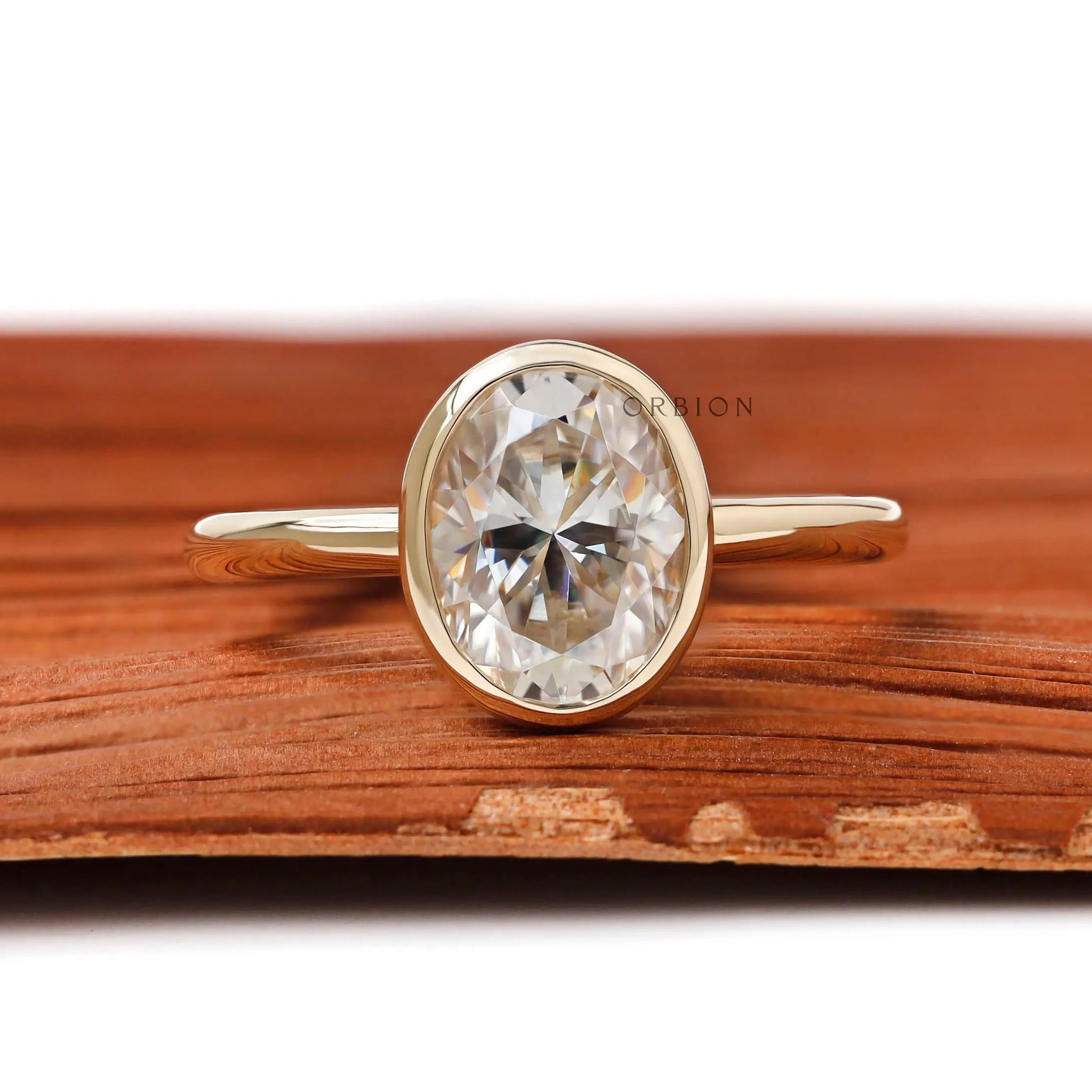 Oval bezel set engagement ring in 14K yellow gold on front view