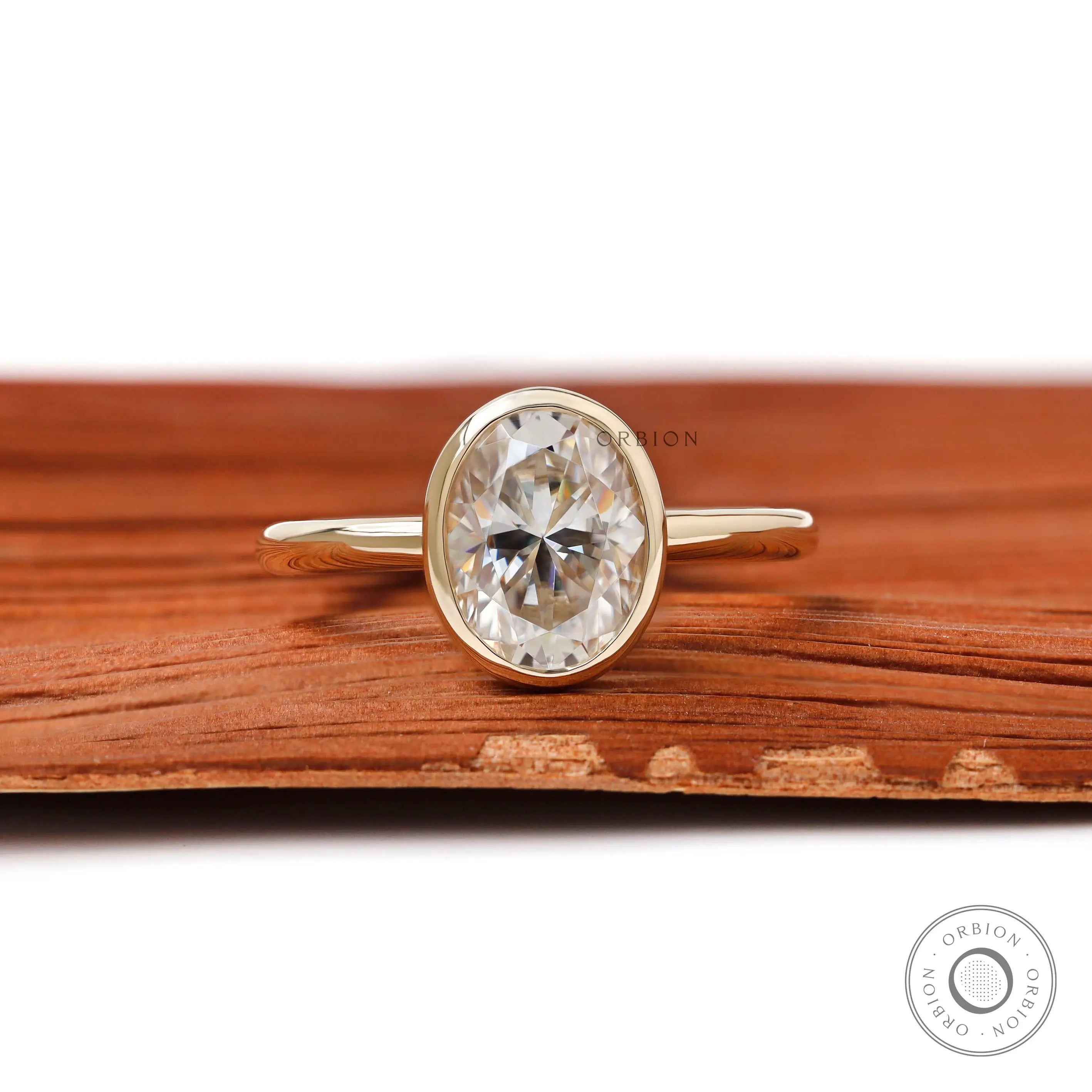 Oval bezel set engagement ring in 14K yellow gold on front view