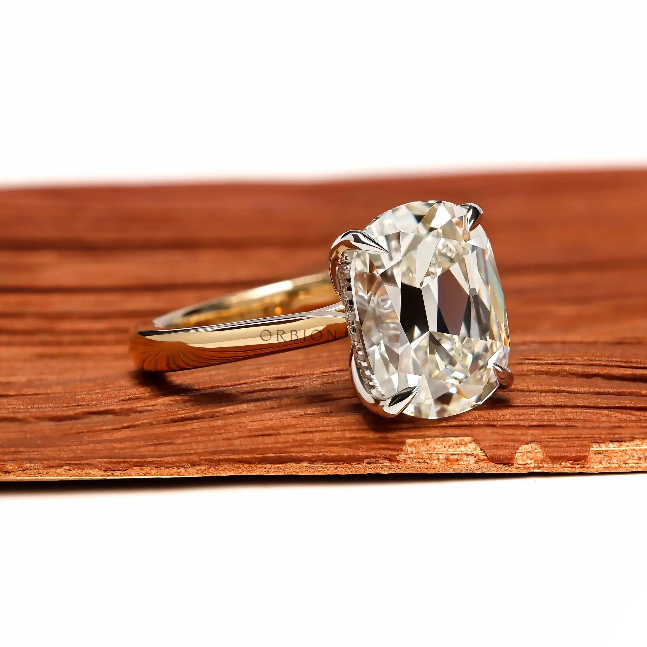 Angled front view elongated cushion solitaire dual tone ring
