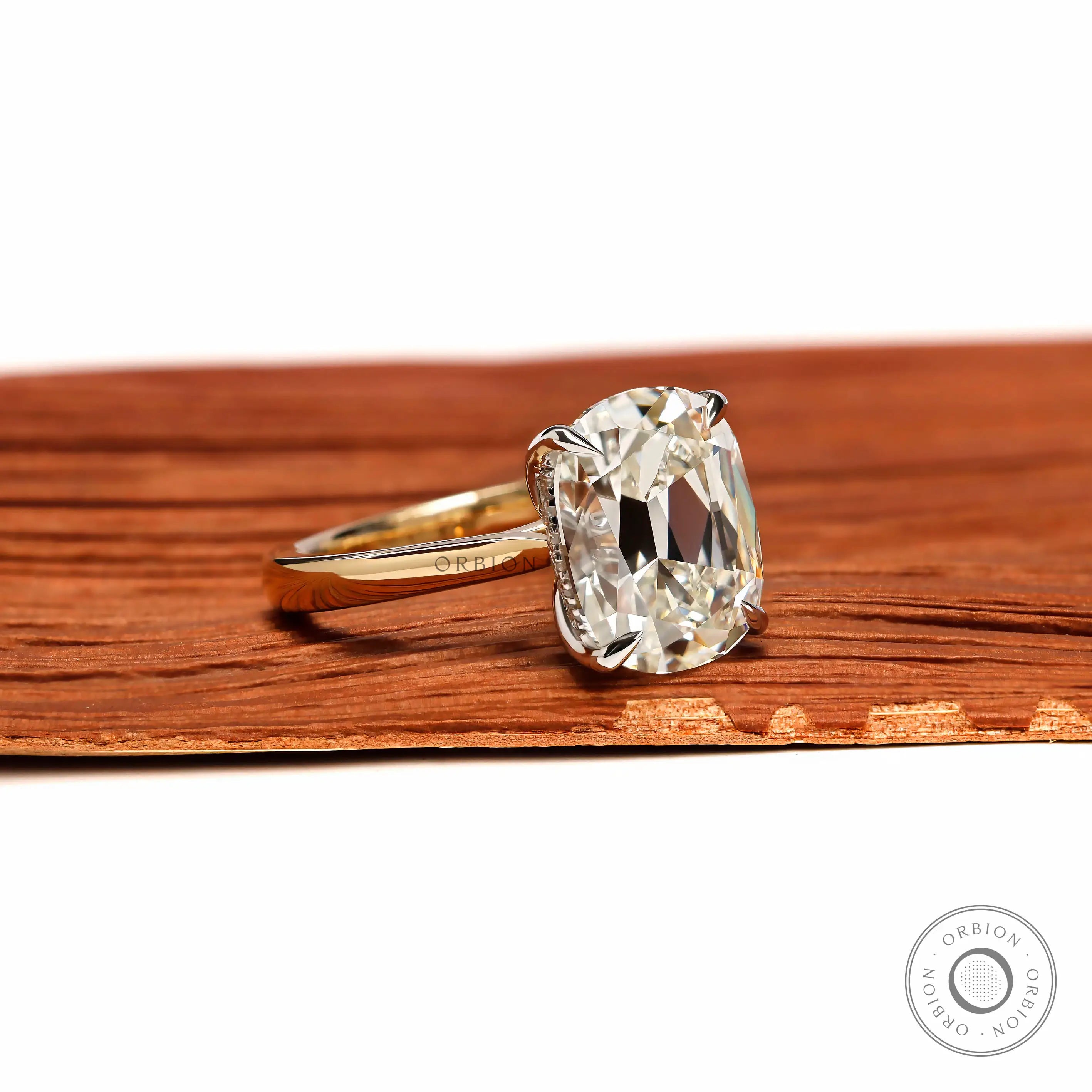 Angled front view elongated cushion solitaire dual tone ring