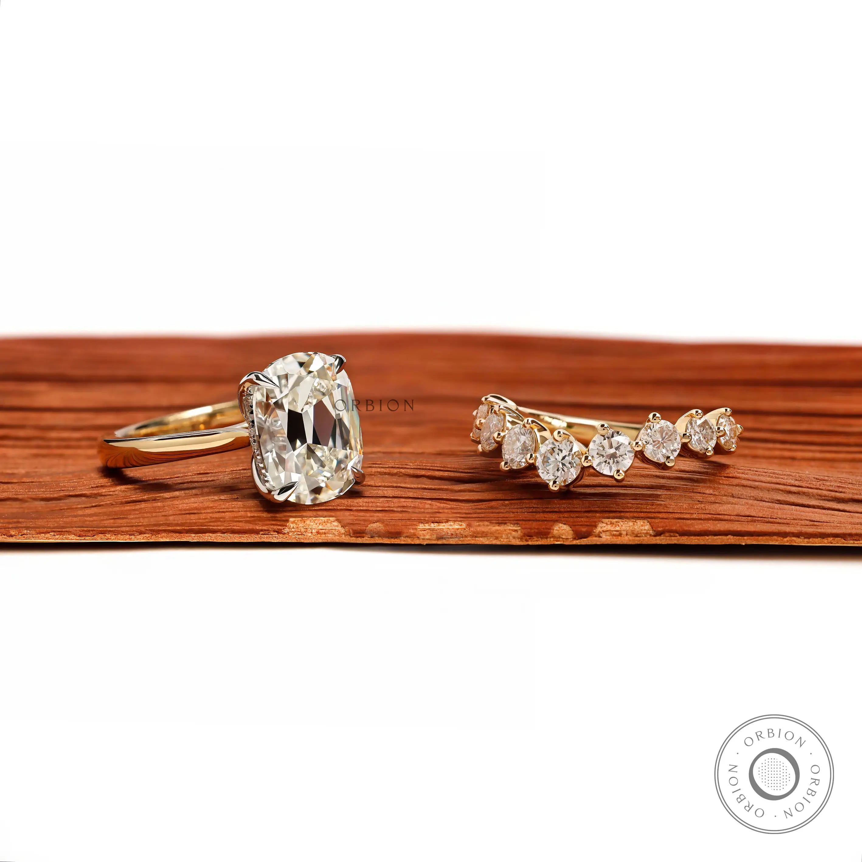 Angled front view of antique two tone ring set with curved band