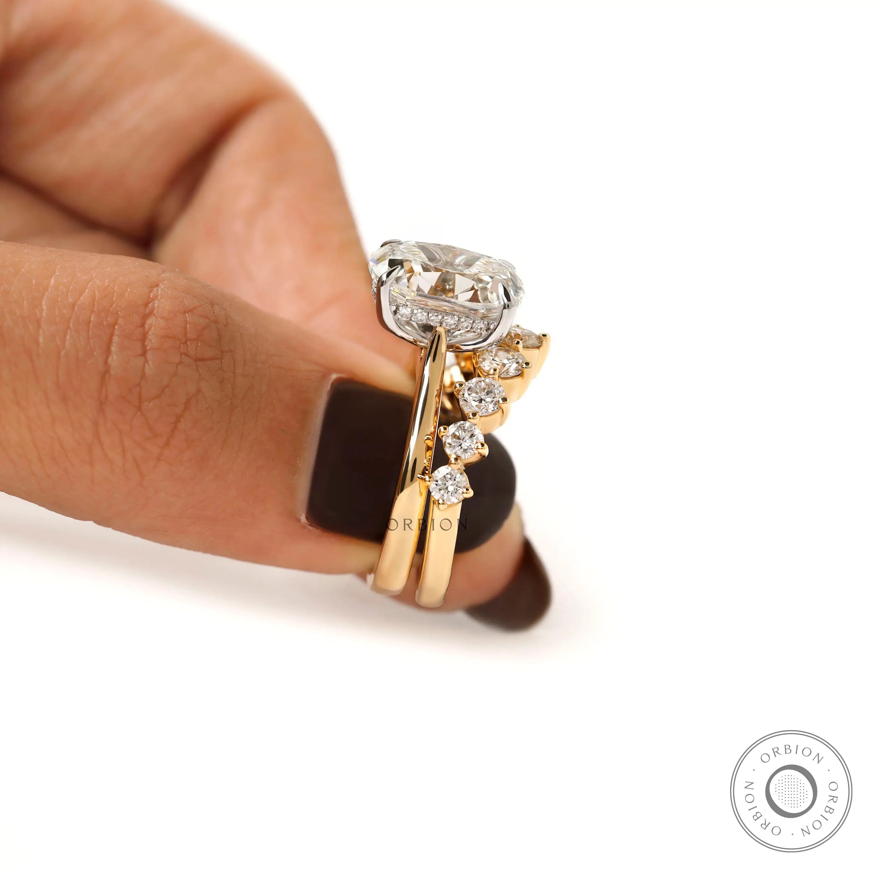 Side stacked view of two tone hidden halo ring set