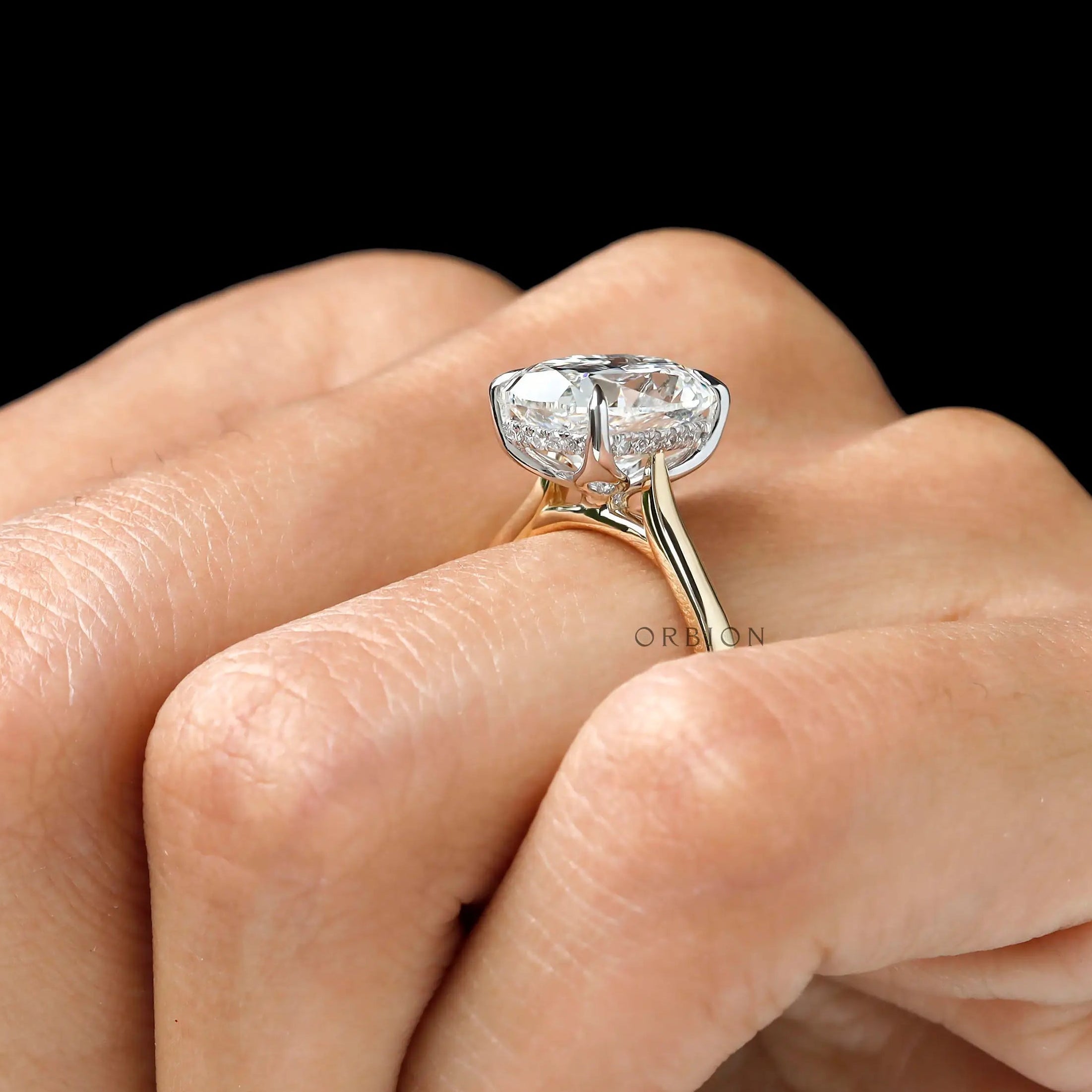 Angled hand shot elongated cushion dual tone solitaire ring