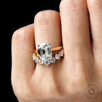 Top hand view of hidden halo engagement ring with curved band