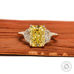 Radiant cut yellow diamond three stone engagement ring front view