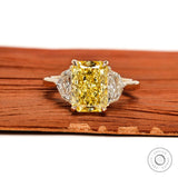 Radiant cut yellow diamond three stone engagement ring front view