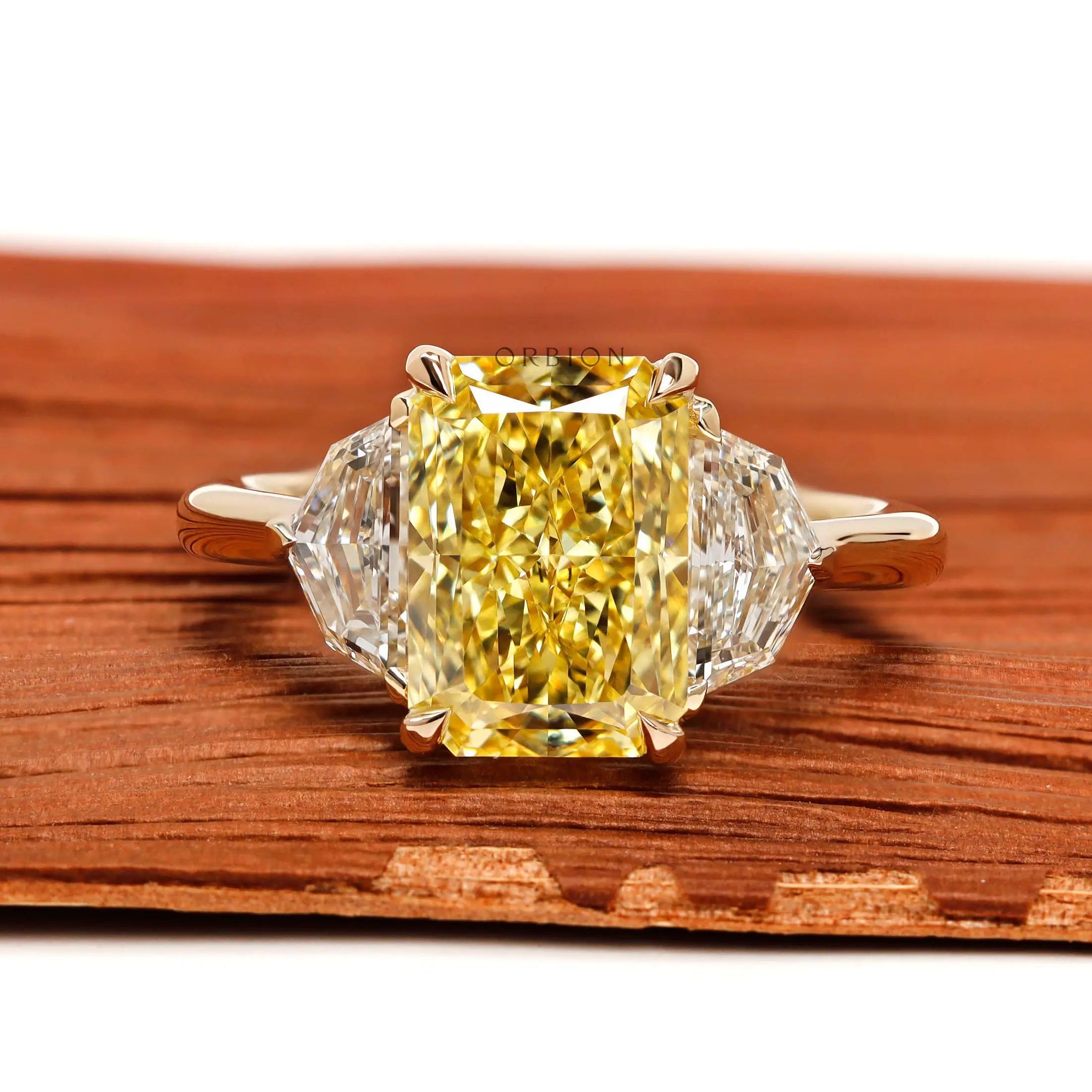 Radiant cut yellow diamond three stone engagement ring front view
