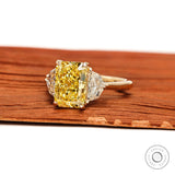 Angled view radiant yellow lab diamond ring with epaulette side stones