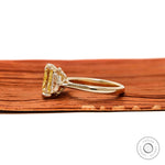 Side profile radiant yellow diamond engagement ring in polished yellow gold