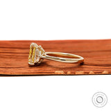 Side profile radiant yellow diamond engagement ring in polished yellow gold