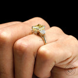 Close hand view radiant yellow diamond ring with side stones