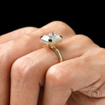 emerald cut yellow gold engagement ring with pave halo bezel