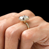 emerald cut yellow gold engagement ring with pave halo bezel