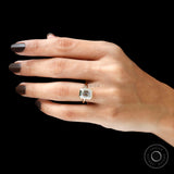 emerald cut solitaire ring on hand yellow gold bezel setting