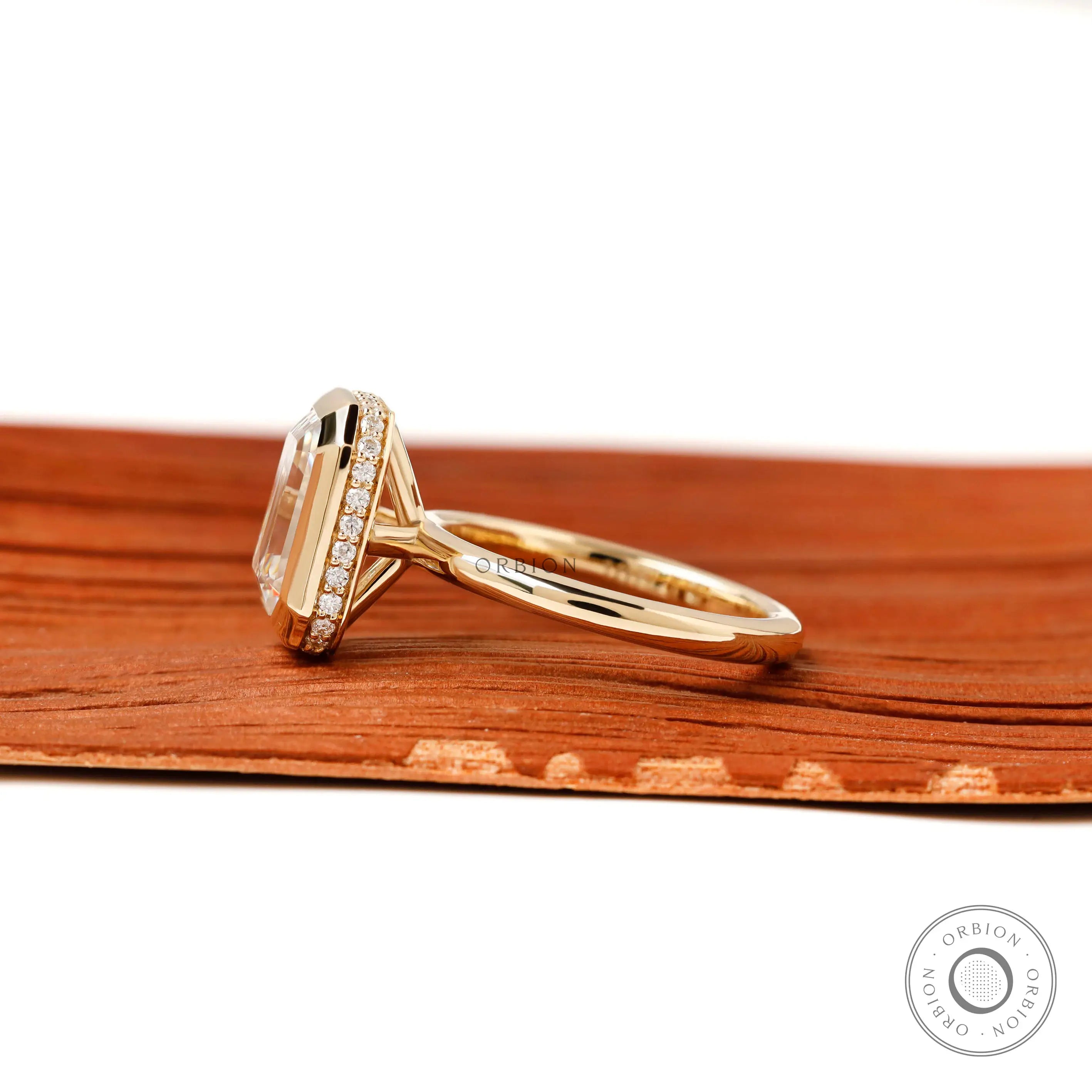 emerald cut engagement ring side profile pave halo accent