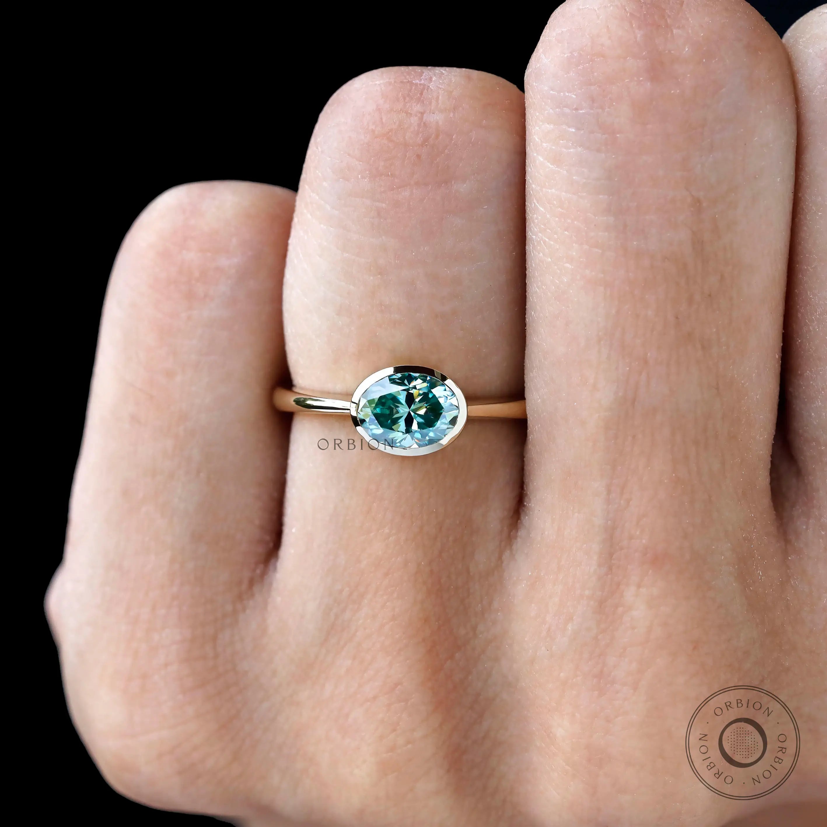 Bezel set oval teal moissanite promise ring yellow gold