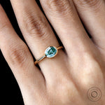Oval east west blue green moissanite ring yellow gold