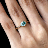 Oval east west blue green moissanite ring yellow gold