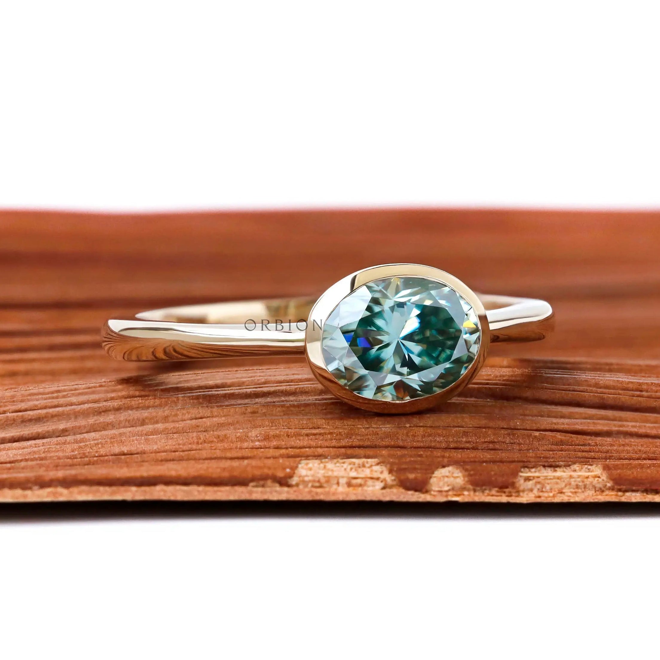 Minimalist oval moissanite bezel engagement ring yellow gold band