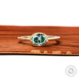 Blue green oval moissanite east west bezel set engagement ring in 10k yellow gold