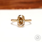 Front view oval dark champagne moissanite half bezel ring