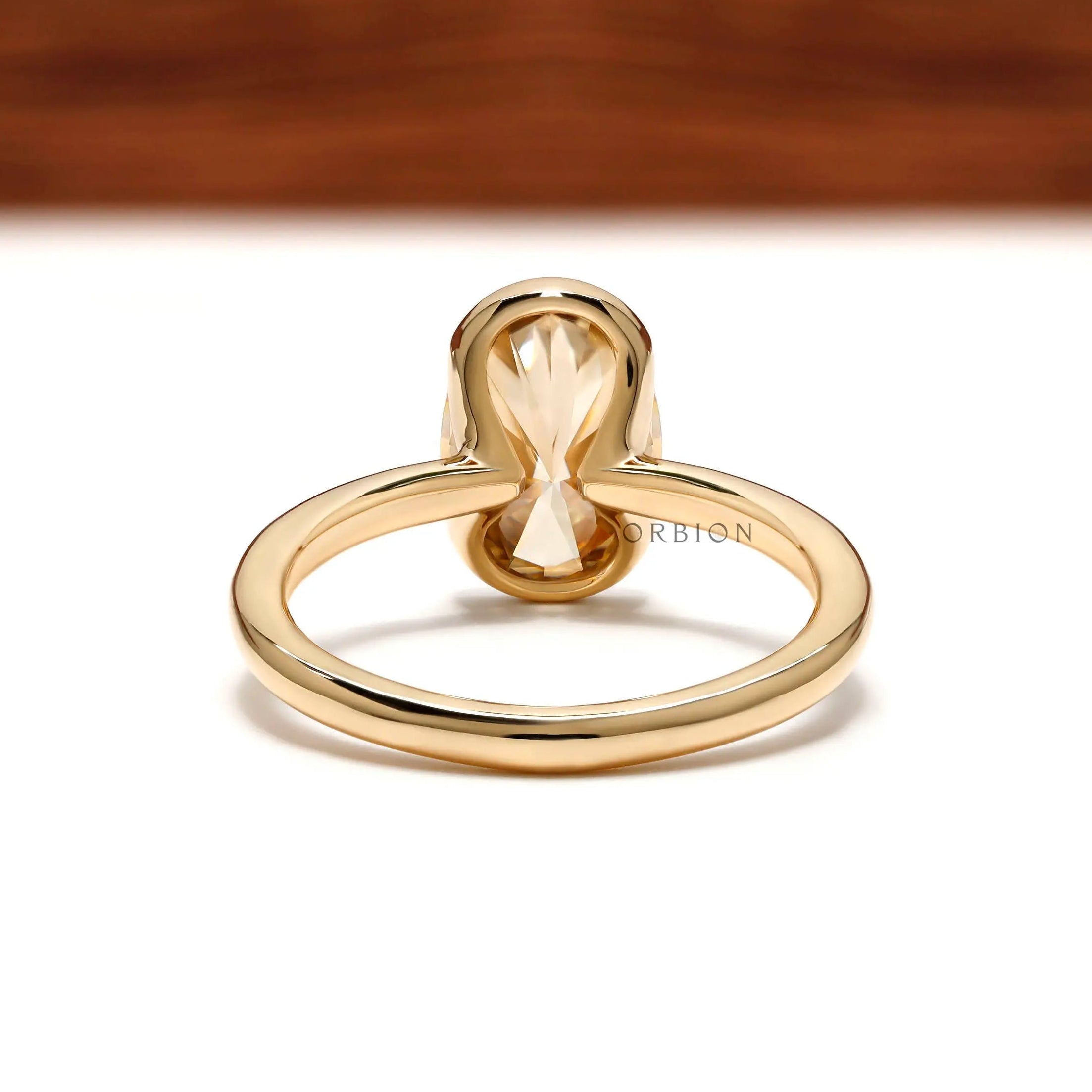 Back view showing open gallery under oval moissanite bezel