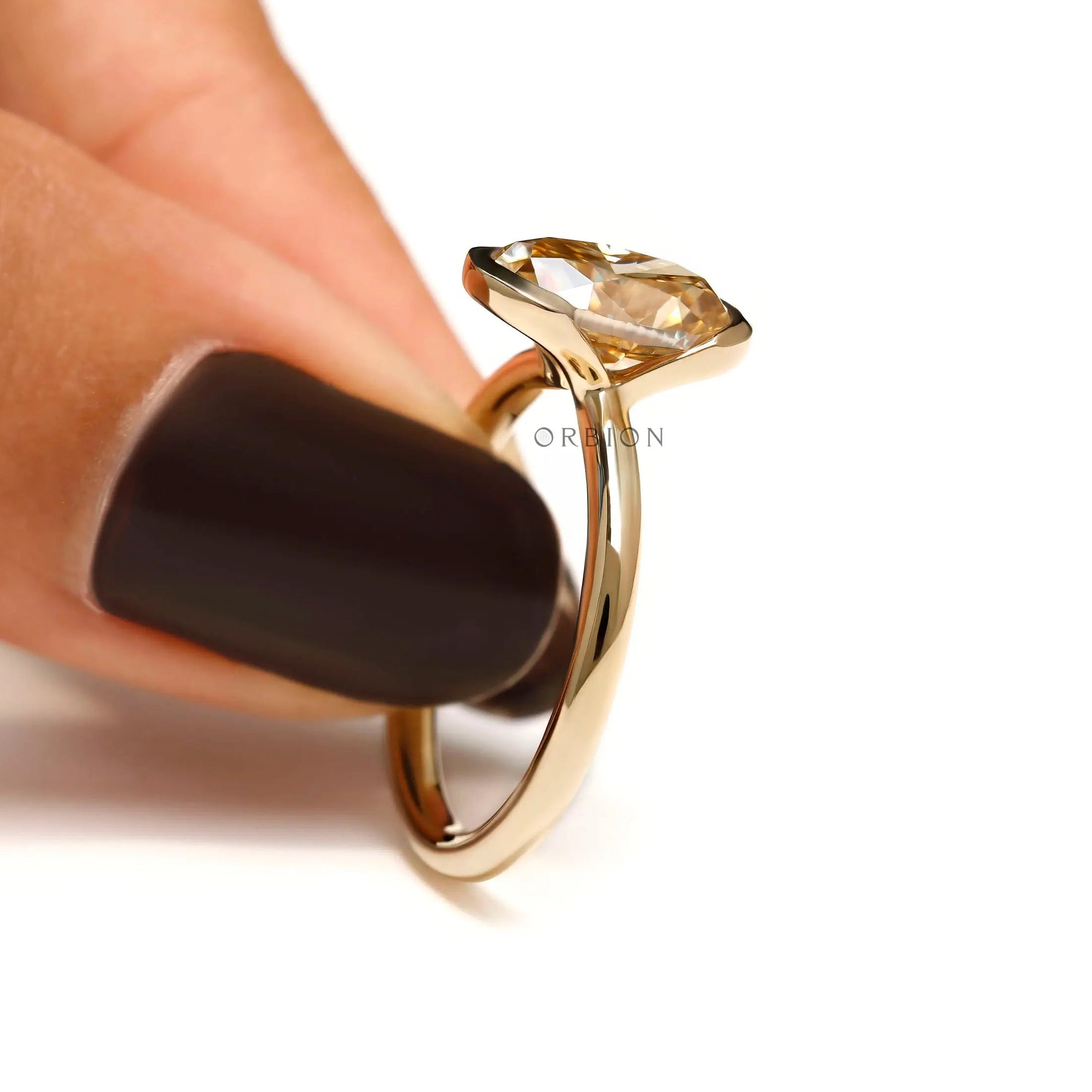 Hand holding ring, side view of half bezel setting
