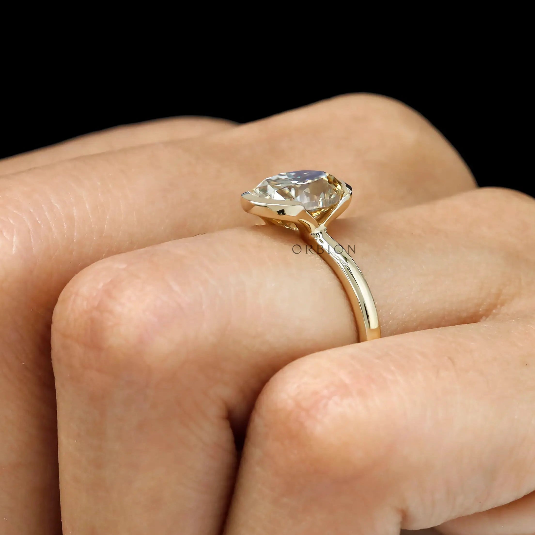 Oval champagne moissanite half bezel engagement ring in 14k yellow gold