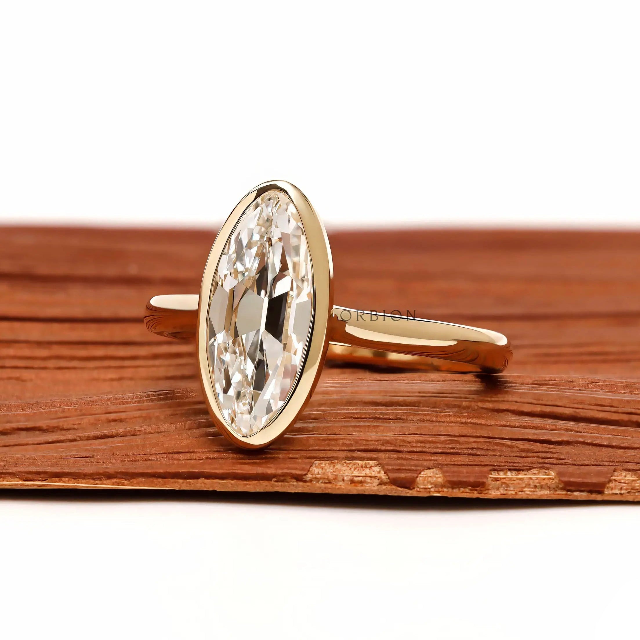 Angled view elongated moval bezel set lab diamond ring