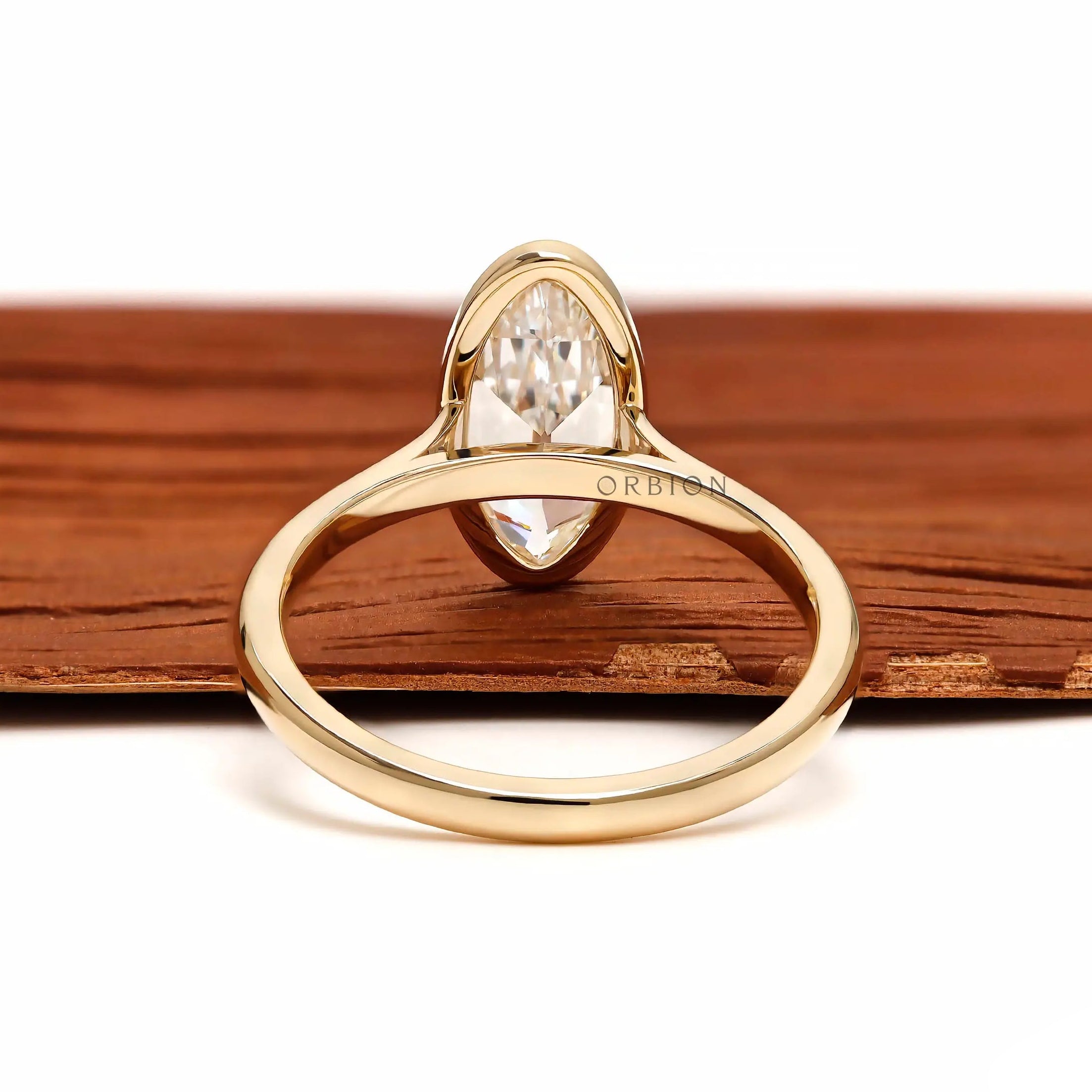 Back view moval bezel solitaire ring in yellow gold