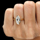 Close hand view elongated moval bezel engagement ring