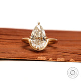 Front view old mine cut pear moissanite bypass ring in matte gold