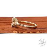 Side profile of oval trilogy ring in yellow gold
