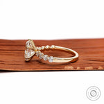 Side profile oval diamond ring with round shoulder stones