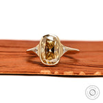 Front view elongated champagne cushion moissanite ring with triangle side stones