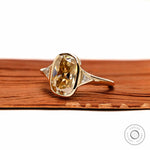 Angled front view champagne cushion moissanite three stone ring in yellow gold