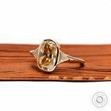 Angled front view champagne cushion moissanite three stone ring in yellow gold