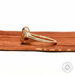 Side profile elongated champagne cushion ring with tapered triangle side stone